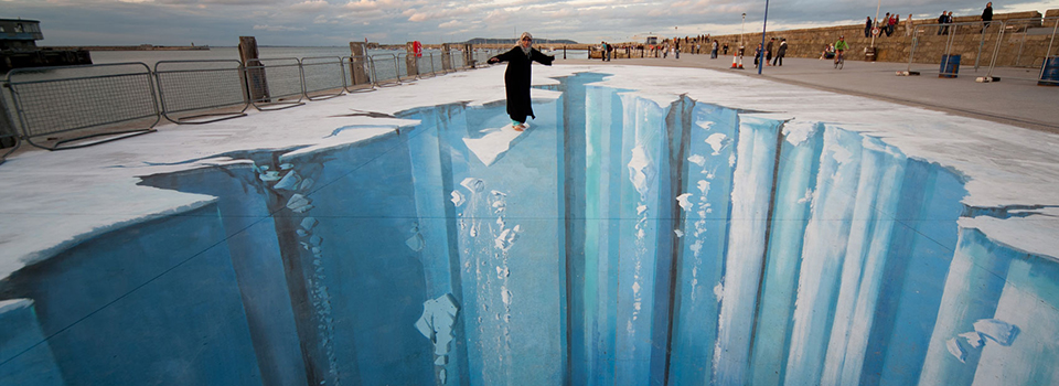 Woman balancing on glacier illusion